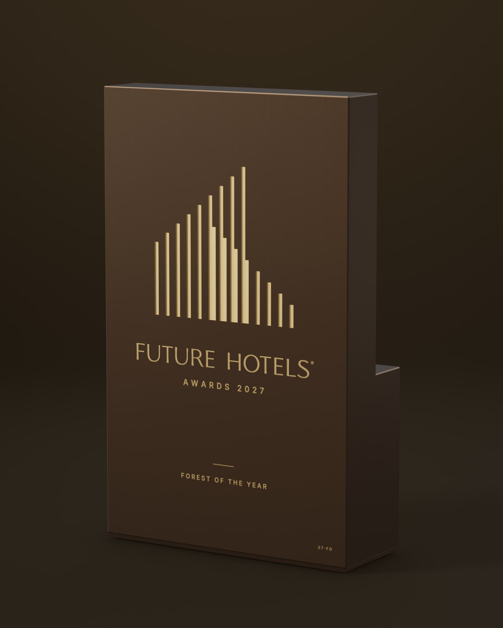 The Future Hotels Award: a dark-bronze block engraved with the Future Hotels symbol and wordmark, its stepped side catching the light.